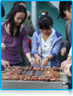 Chinese students at Wittenborg University cooking lamb kebabs August 2012