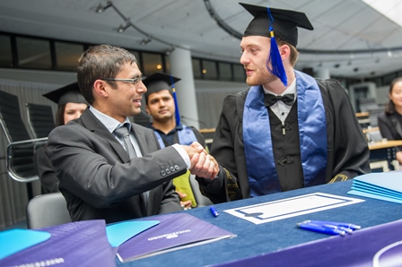 Wittenborg University Registrar Santosh Aryal Congratulates Mario Wolters (Germany) on Receiving his degree.