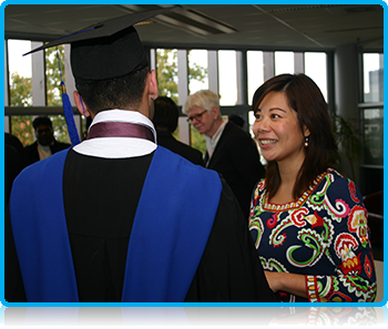 Wittenborg University Director Maggie Feng talking with students at Graduation